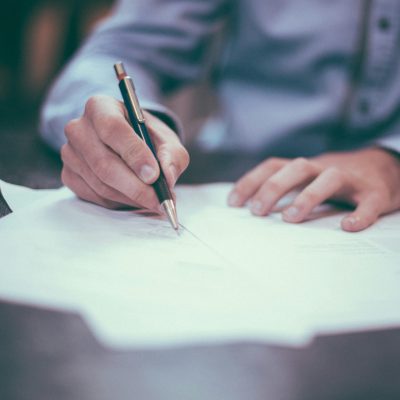 schreibende Person mit Papier